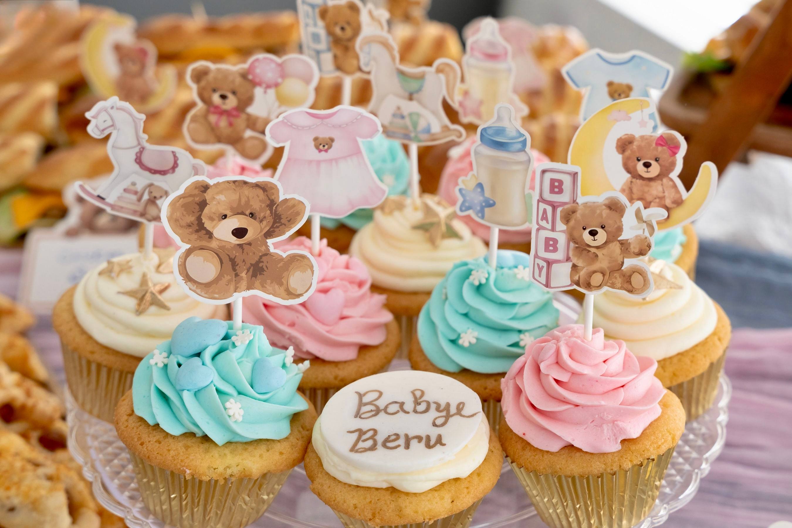 Teddy bear themed cupcakes in pink and blue at a gender reveal party