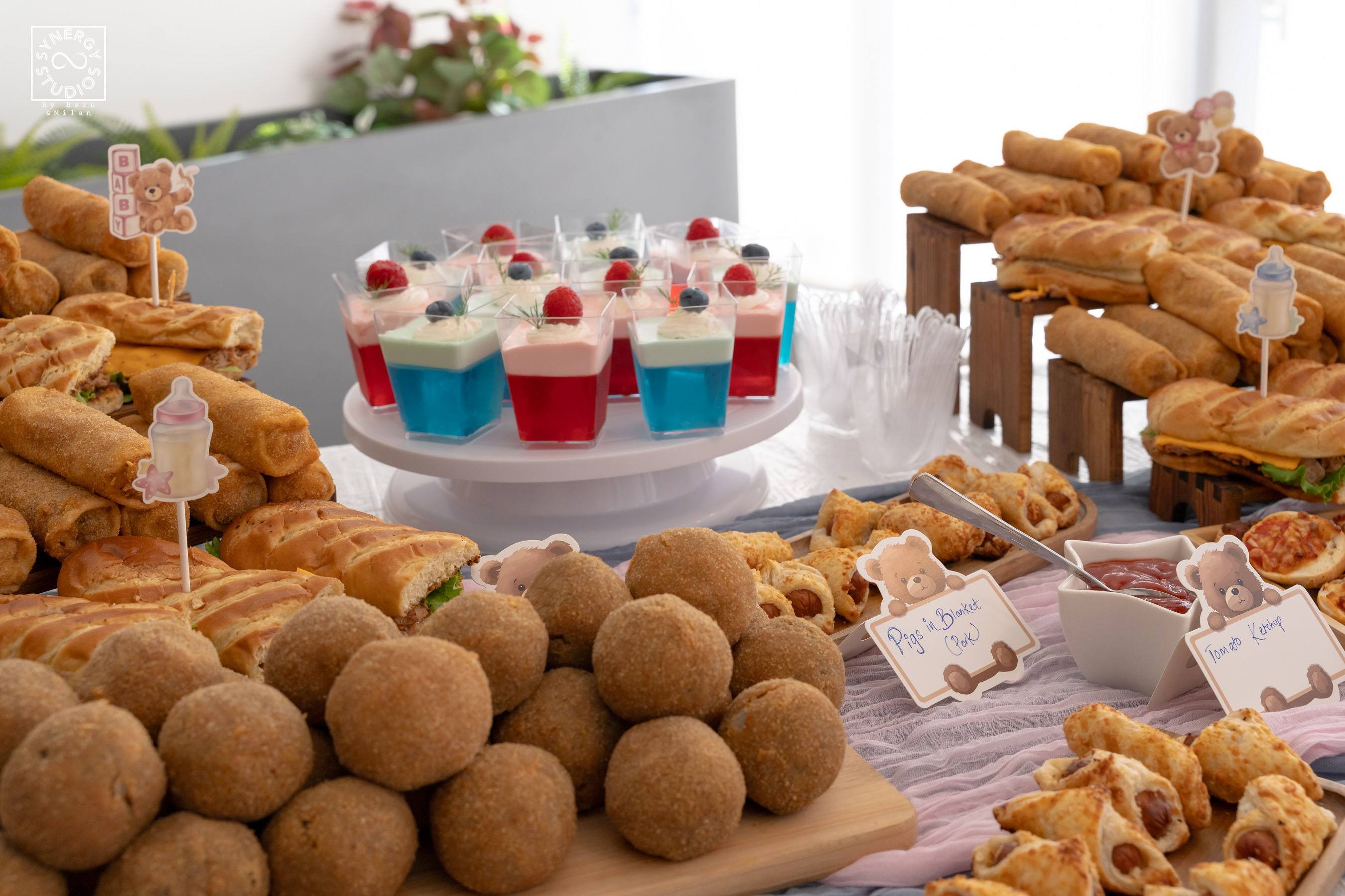 Dessert table with pink and blue cupcakes and pastries