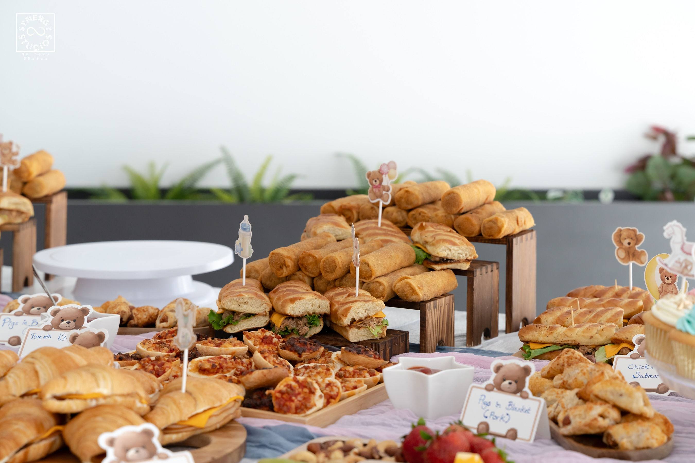 Grazing table filled with sandwiches and baked goods