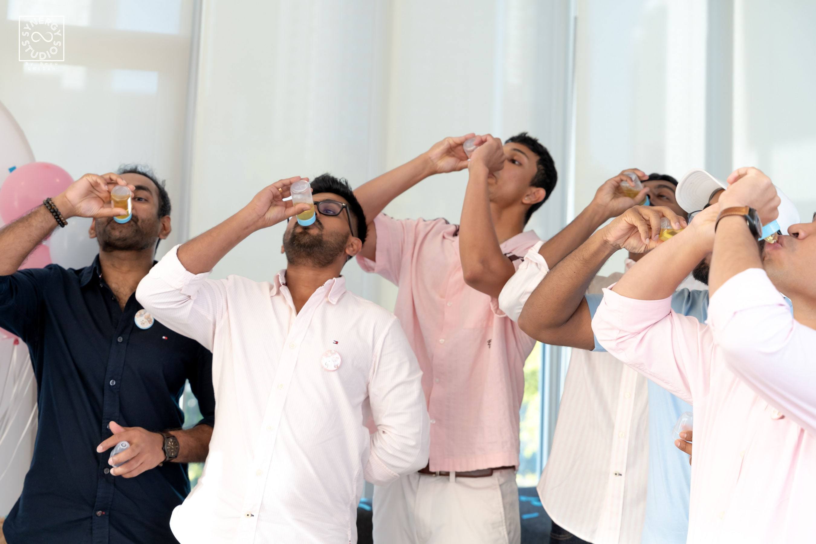Guests raising their drinks in a toast at the party