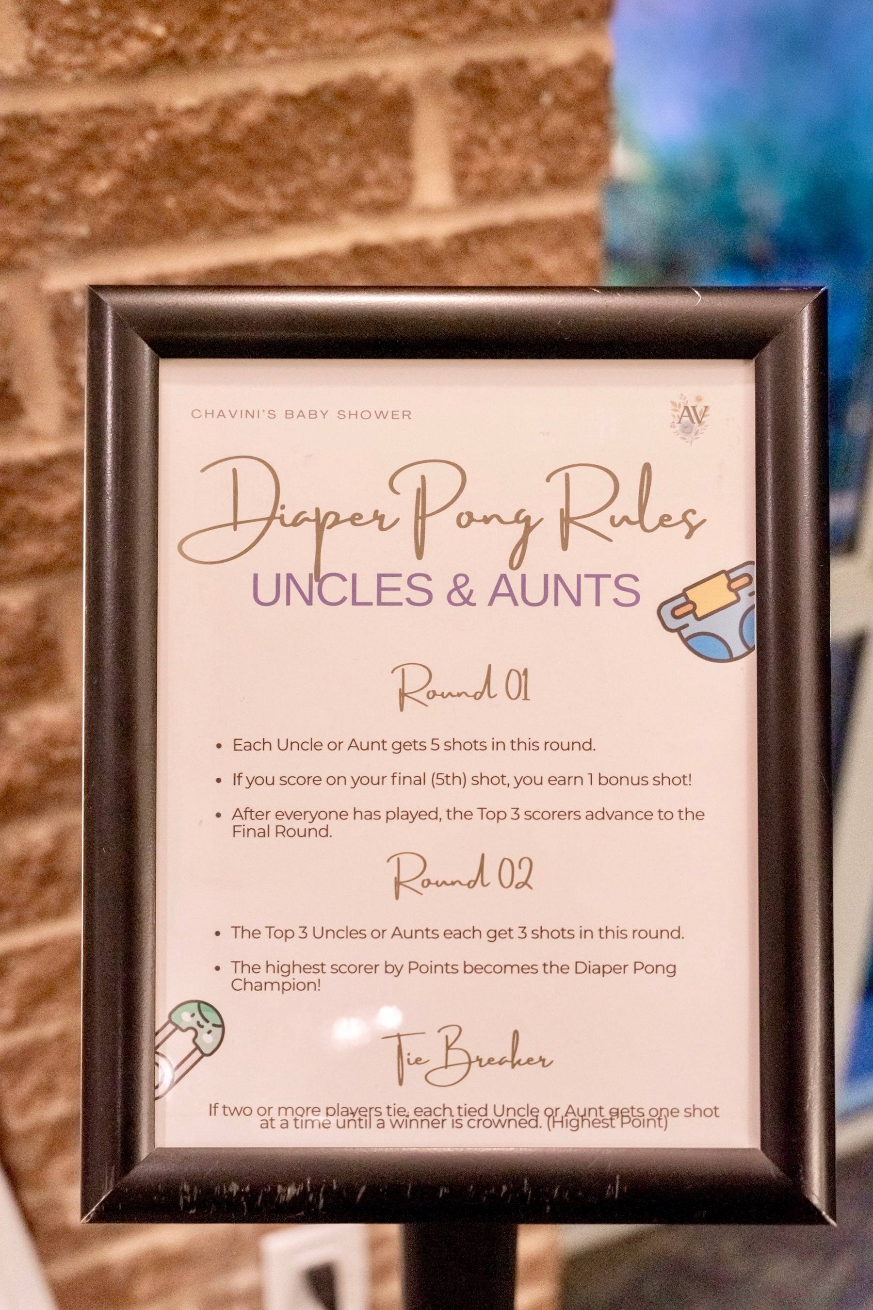 Framed baby shower game rules sign on a brick wall
