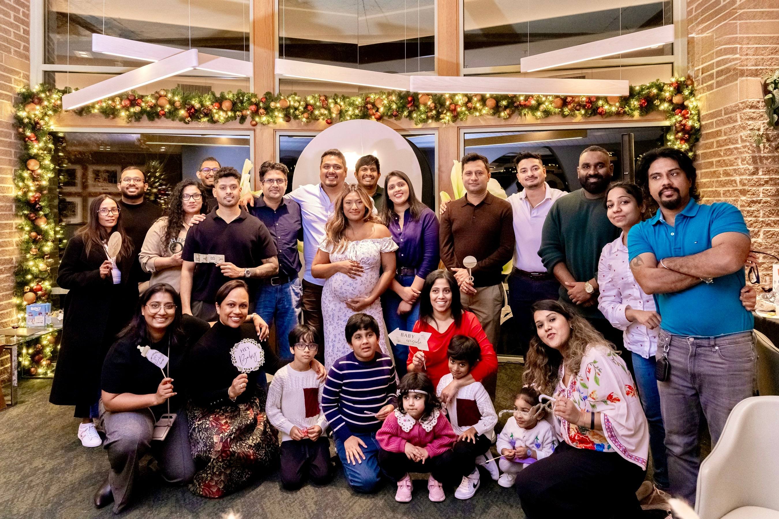 Large family group photo at a festive baby shower