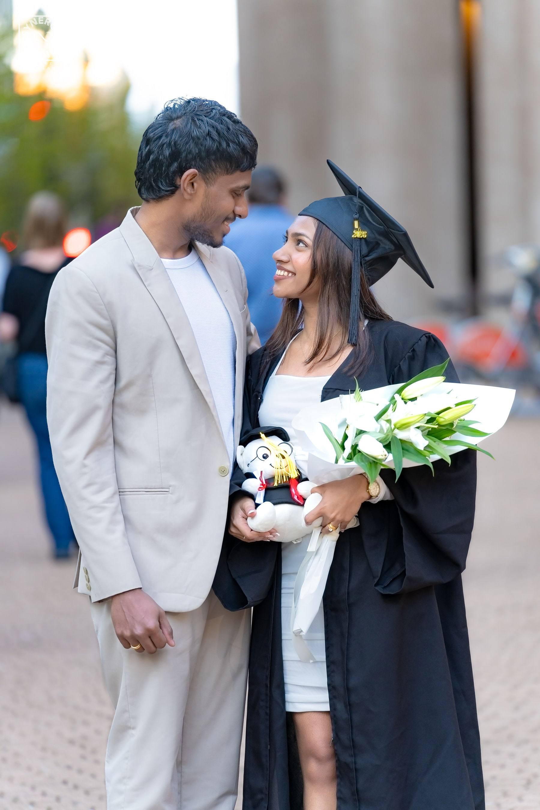 Graduate and her partner sharing a sweet moment on campus