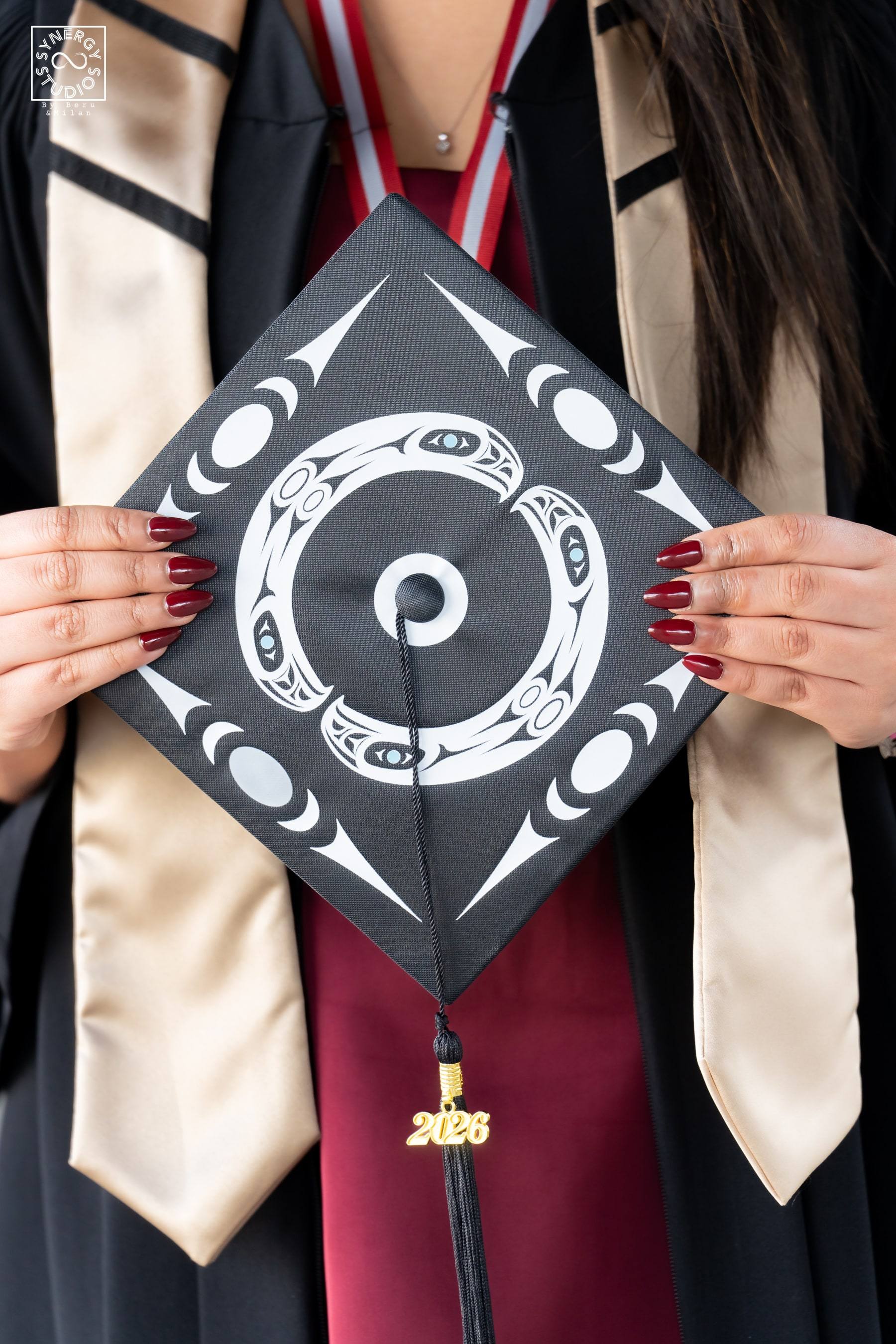 Close up of a graduate holding her hand-decorated graduation cap